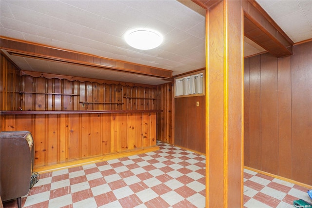 basement featuring wood walls