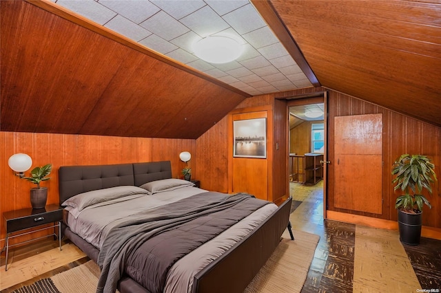 bedroom featuring wooden walls, light parquet flooring, and lofted ceiling