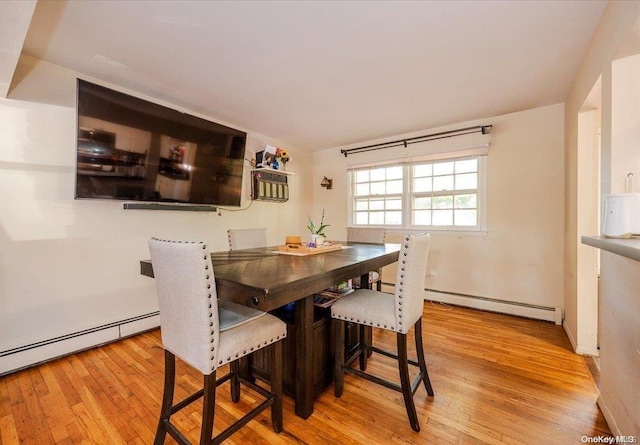 dining room featuring light wood-type flooring and baseboard heating