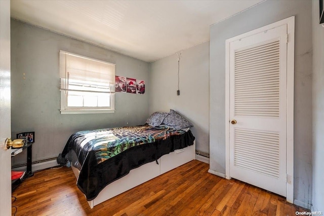 bedroom featuring hardwood / wood-style flooring and a baseboard radiator