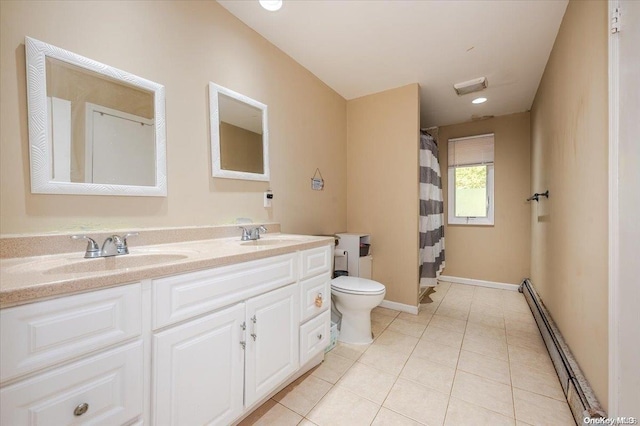 bathroom with toilet, vanity, tile patterned floors, and a baseboard heating unit