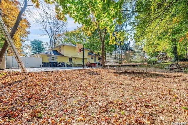 view of yard with a patio and a trampoline