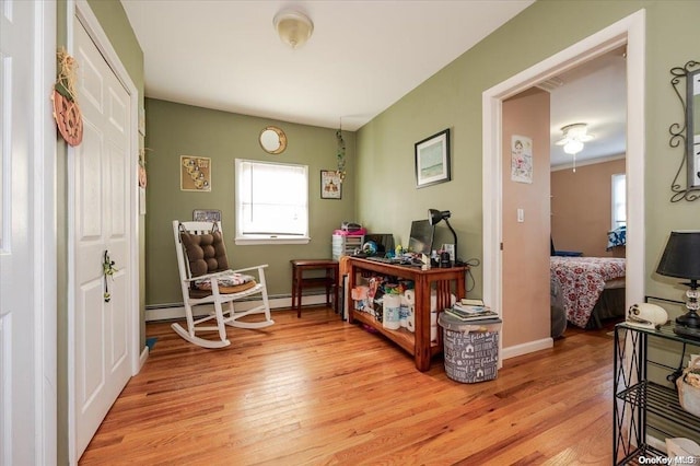 sitting room featuring light hardwood / wood-style floors and a baseboard radiator