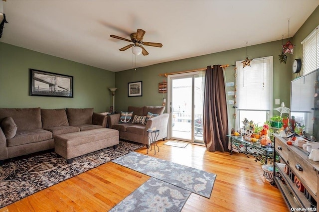 living room featuring light hardwood / wood-style floors and ceiling fan