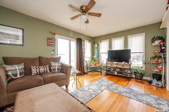 living room featuring hardwood / wood-style flooring and ceiling fan