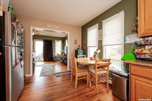 dining space featuring ceiling fan and light wood-type flooring