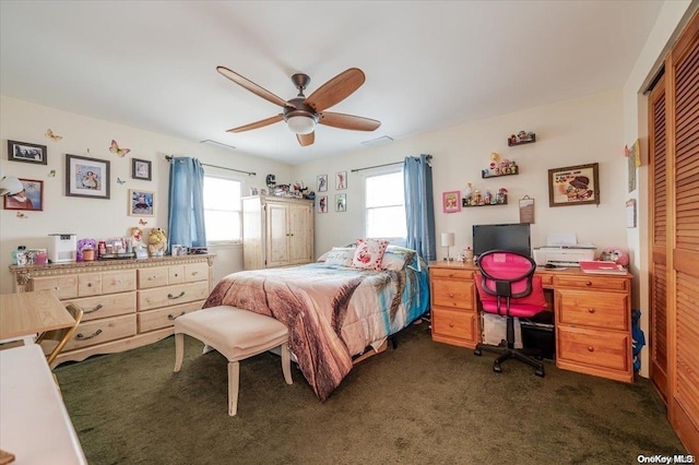 bedroom featuring ceiling fan, a closet, and dark colored carpet