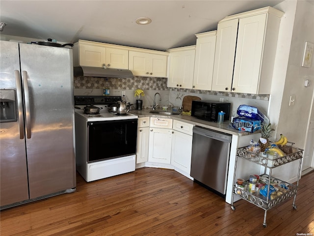 kitchen featuring dark hardwood / wood-style floors, sink, stainless steel appliances, and tasteful backsplash