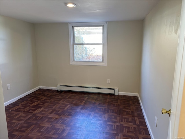 unfurnished room featuring baseboard heating