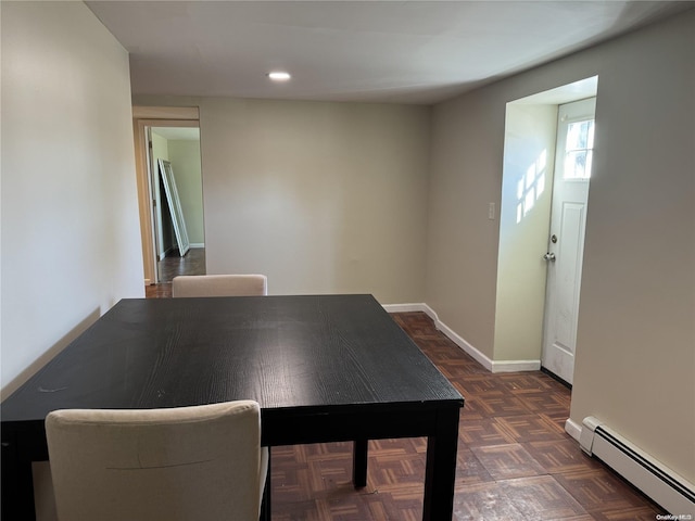 interior space featuring dark parquet floors and a baseboard heating unit