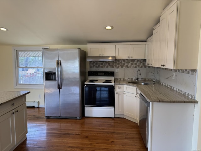 kitchen with baseboard heating, a sink, stainless steel appliances, white cabinetry, and under cabinet range hood