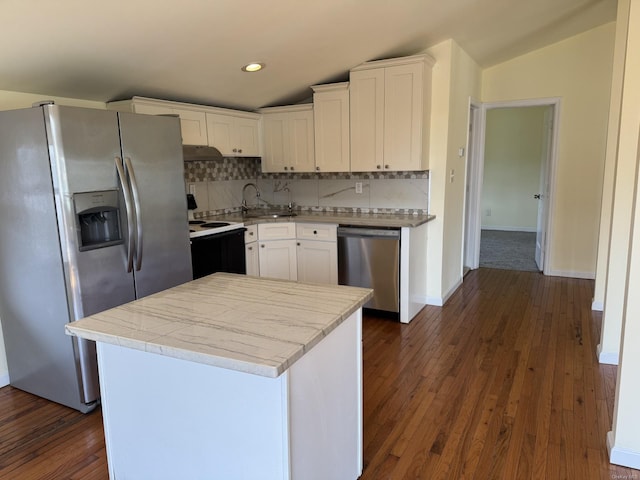 kitchen featuring a sink, white cabinets, backsplash, appliances with stainless steel finishes, and dark wood-style floors