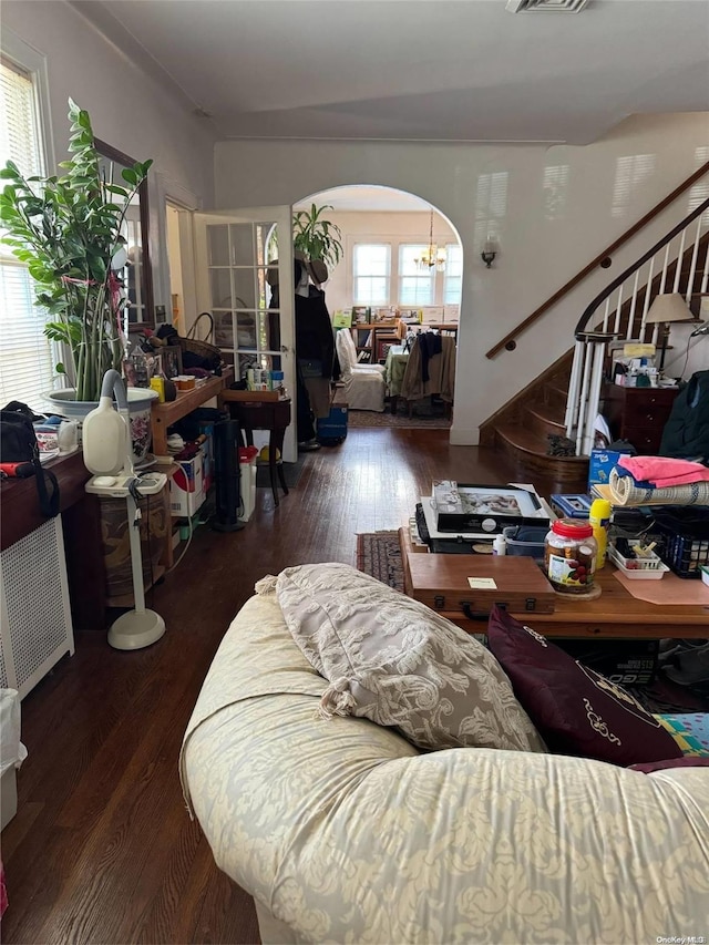 living room featuring dark hardwood / wood-style floors and a notable chandelier