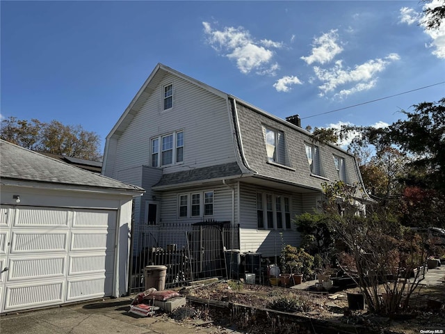 rear view of house featuring a garage