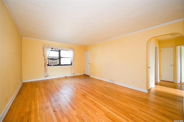 unfurnished room featuring hardwood / wood-style flooring and crown molding