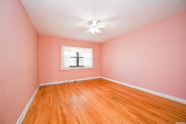 spare room featuring ceiling fan and light hardwood / wood-style flooring