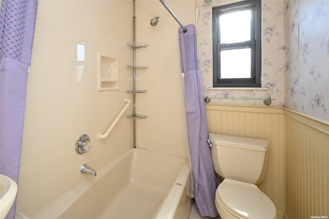 bathroom with shower / bath combination with curtain and toilet