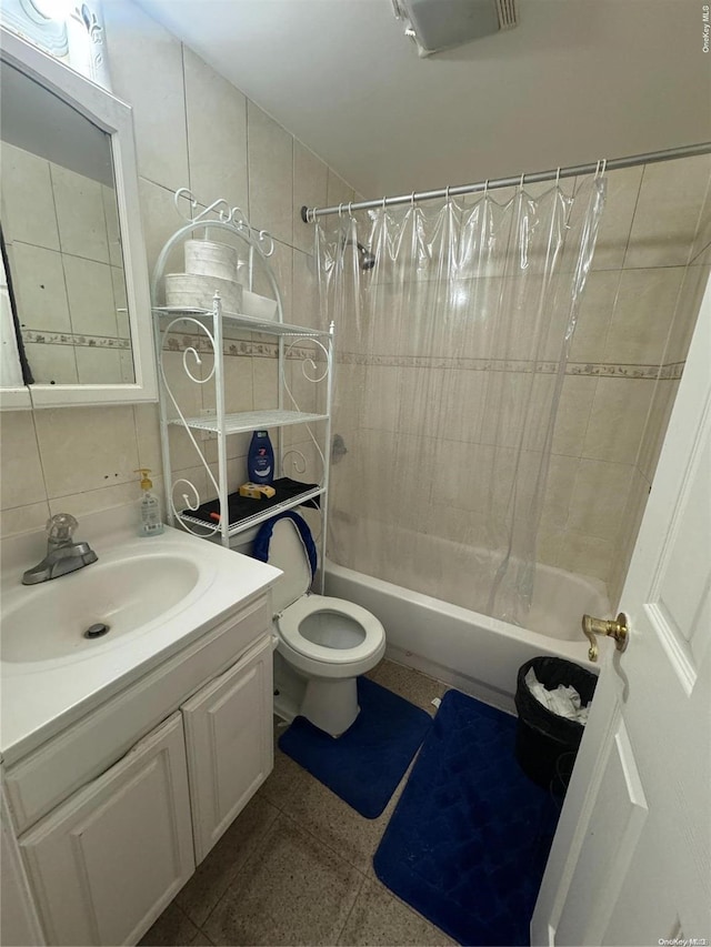 full bathroom featuring shower / bath combo with shower curtain, vanity, tile walls, and toilet