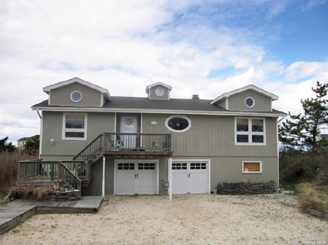 view of front property featuring a garage and a wooden deck