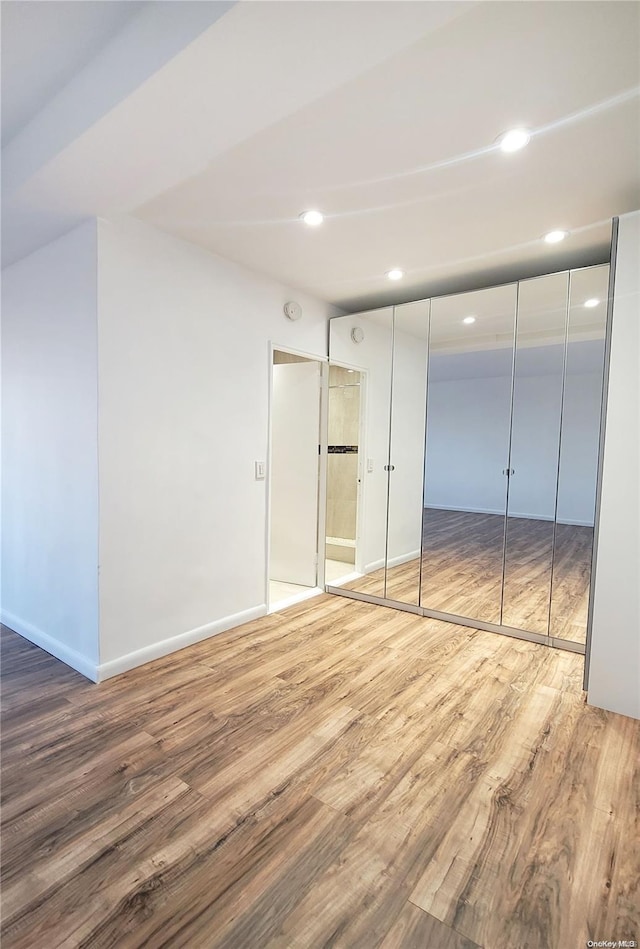 unfurnished bedroom featuring wood-type flooring