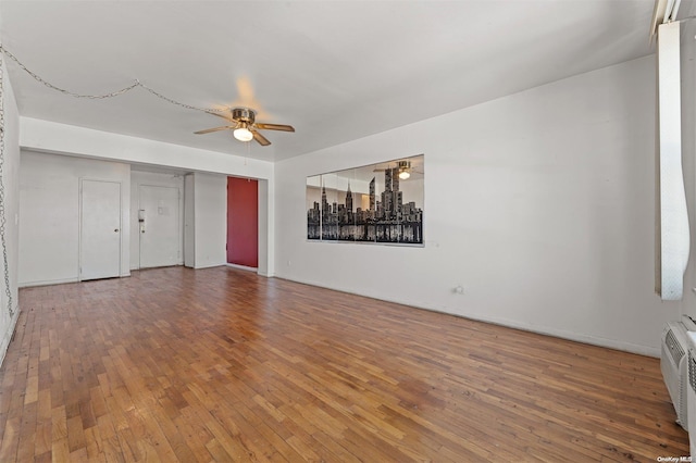 unfurnished living room featuring hardwood / wood-style floors and ceiling fan