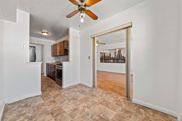 kitchen with light hardwood / wood-style floors, stainless steel range oven, sink, and stainless steel range with gas stovetop