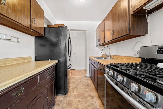 kitchen featuring appliances with stainless steel finishes, extractor fan, and sink