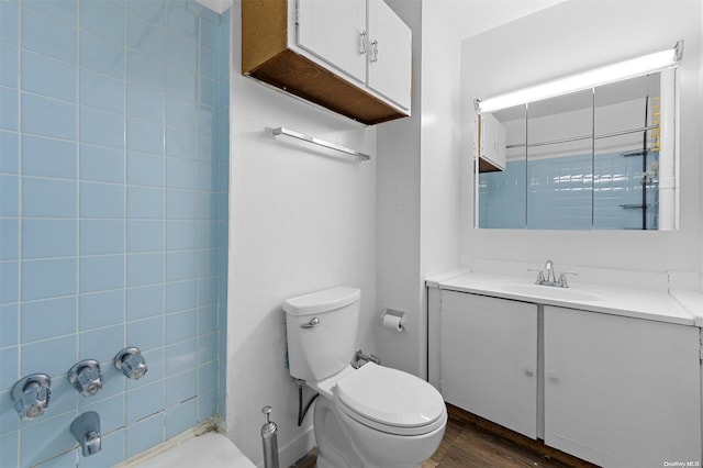 bathroom with hardwood / wood-style flooring, vanity, and toilet