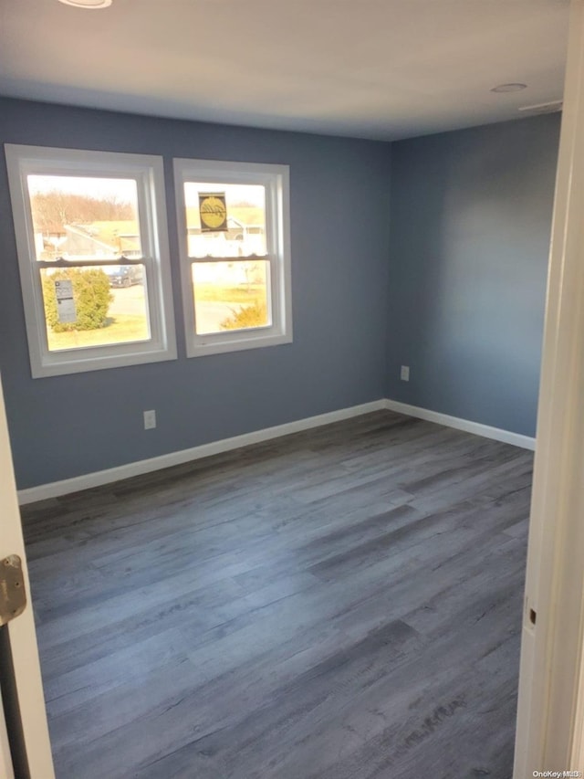 empty room featuring dark hardwood / wood-style floors and a wealth of natural light