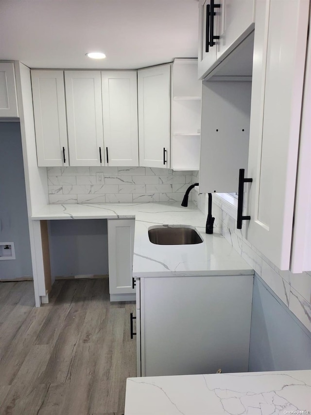 washroom featuring sink and light hardwood / wood-style flooring