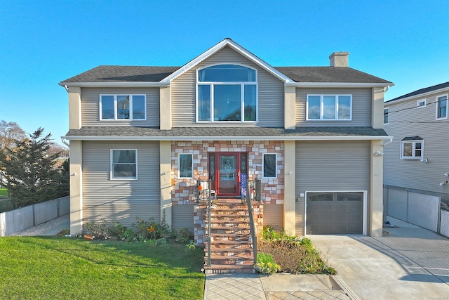 view of front of home with a front lawn and a garage