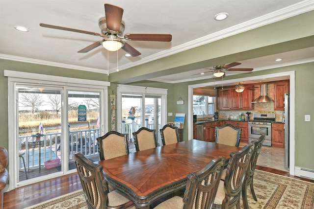 dining area with light hardwood / wood-style floors, ceiling fan, crown molding, and sink