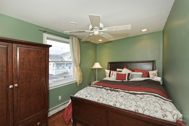 bedroom featuring ceiling fan, dark wood-type flooring, and a baseboard radiator