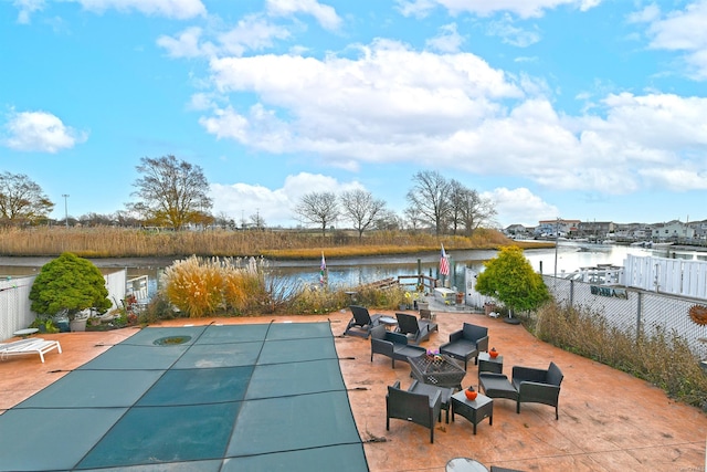 view of pool with a water view and a patio area