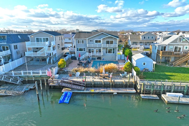 back of house with a water view and a balcony