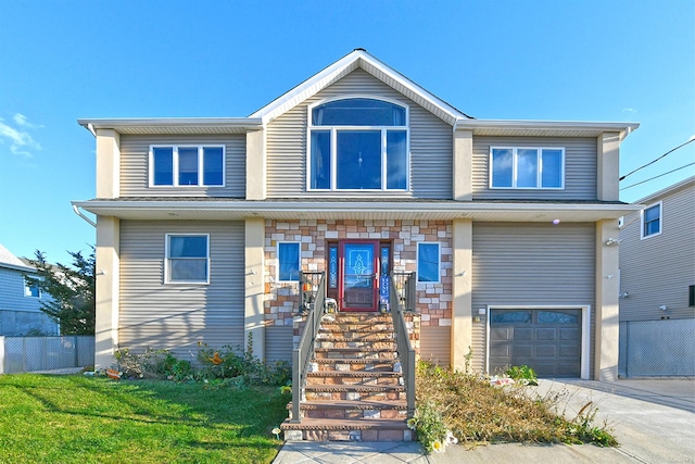 view of front of home featuring a garage and a front yard