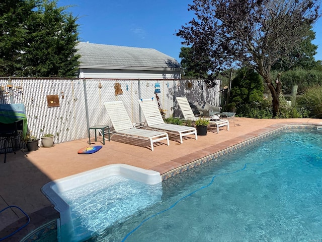 view of swimming pool featuring a patio area