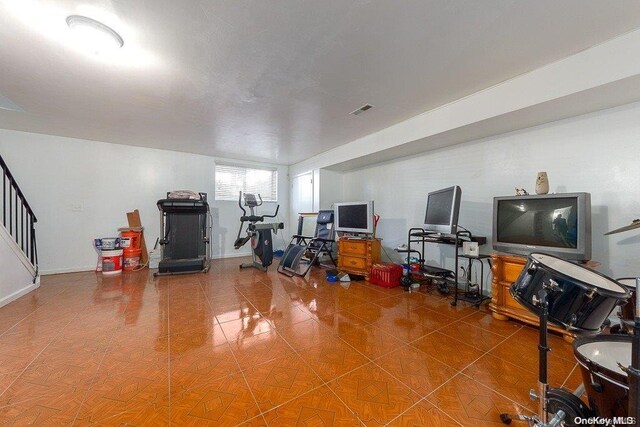 exercise room with tile patterned floors