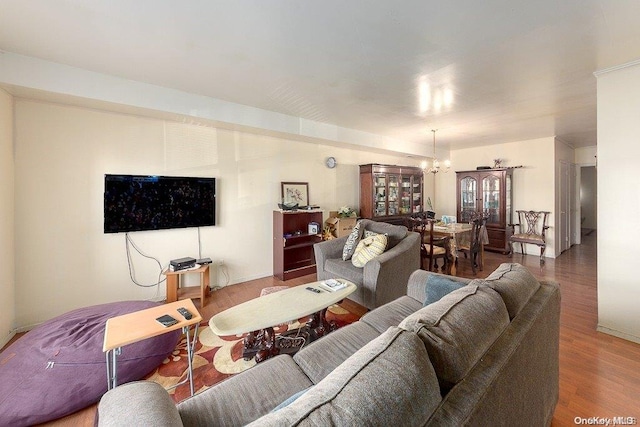 living room with hardwood / wood-style floors and a chandelier