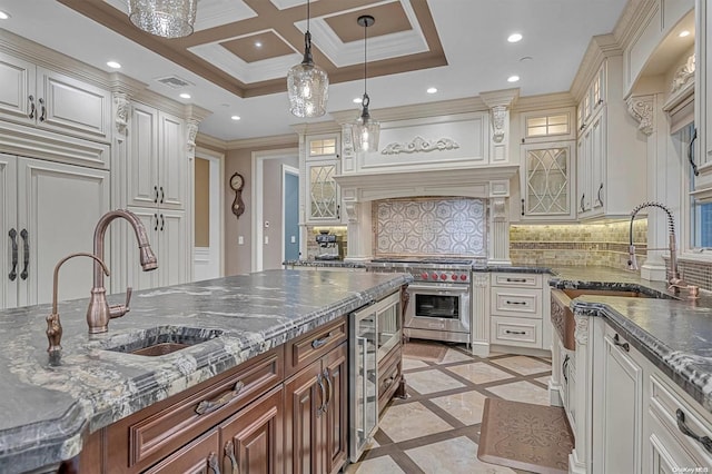 kitchen with pendant lighting, double oven range, backsplash, sink, and ornamental molding