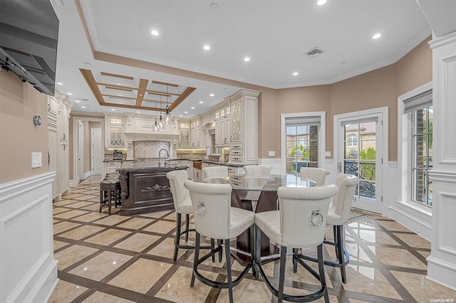 dining area featuring sink and crown molding