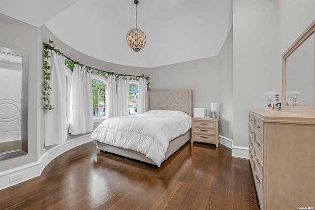 bedroom with dark hardwood / wood-style floors and vaulted ceiling