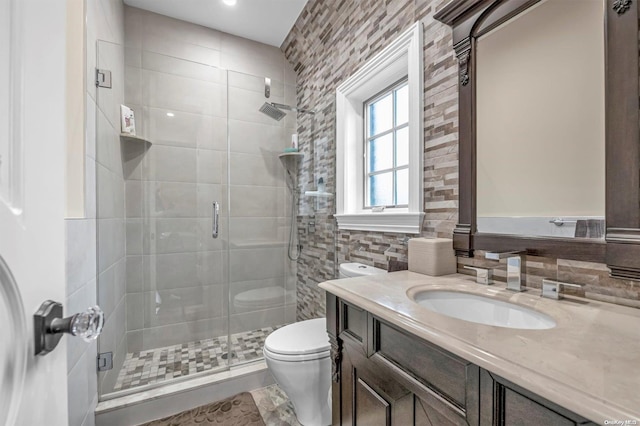 bathroom featuring vanity, toilet, an enclosed shower, and tile walls