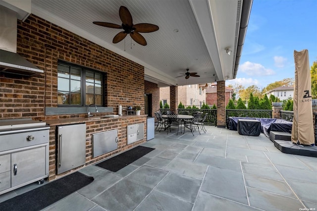 view of patio featuring ceiling fan and exterior kitchen