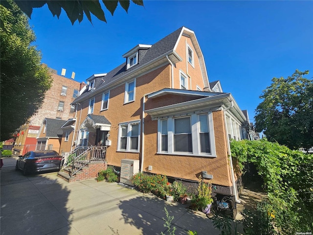 view of side of home featuring central air condition unit