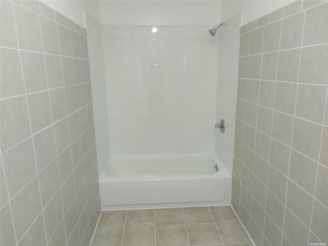 bathroom with tile patterned floors and tiled shower / bath combo