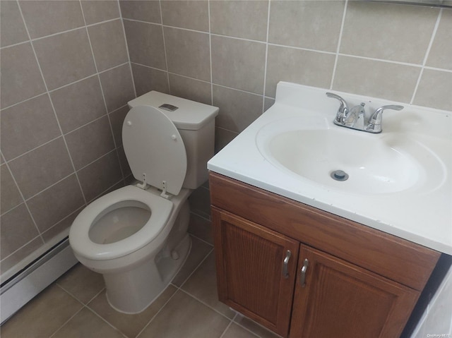 bathroom featuring tile patterned floors, toilet, vanity, and a baseboard heating unit