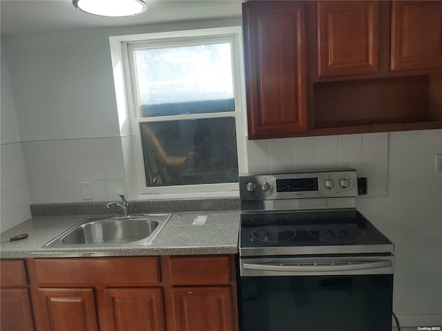 kitchen with backsplash, stainless steel electric range oven, and sink