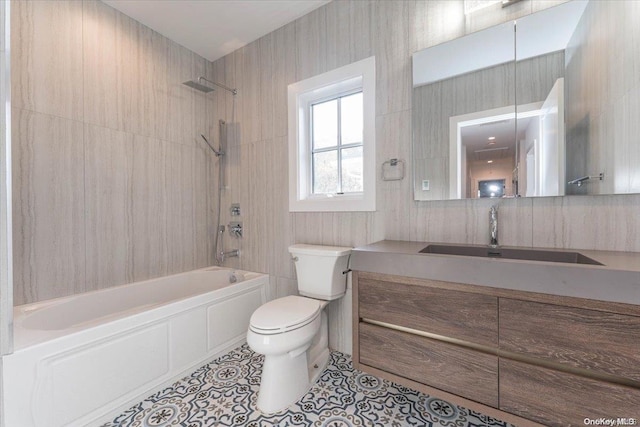 full bathroom featuring toilet, vanity, tile patterned floors, and tiled shower / bath combo