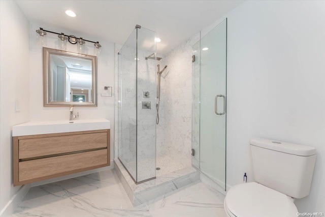 bathroom with toilet, a shower with door, and vanity